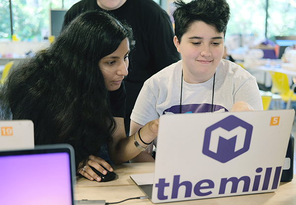 An educator from the UW Makerspace helps a student with a disability on a computing project. An educator from the UW Makerspace helps a student with a disability on a computing project.