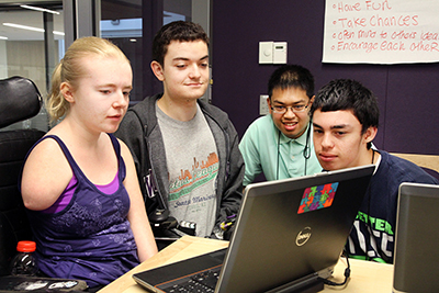 Several students work on the computer.