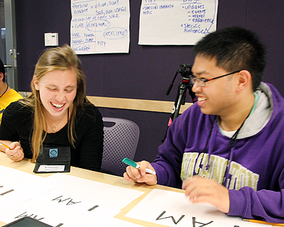 Image of students laughing while working