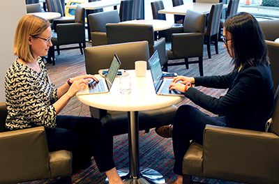 Two participants work on computers.