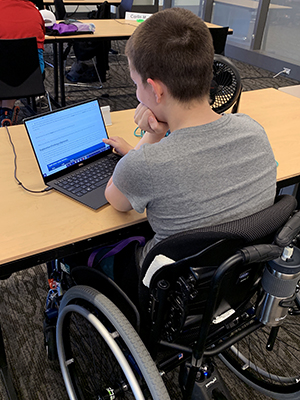 A student in a wheelchair uses the computer.