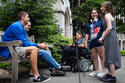 Students film video outside.