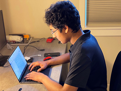 Rohit works on his laptop.