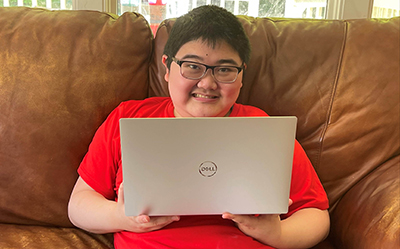 Kevin shows off his computer. Kevin shows off his computer.