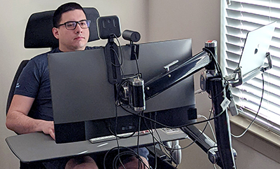 A student works using assistive technology on his computer.