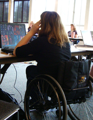 Photo of a student in wheelchair using a laptop.