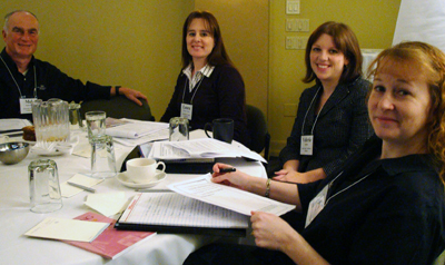 Four faculty members sitting at a table. Image of four faculty members sitting at a table.