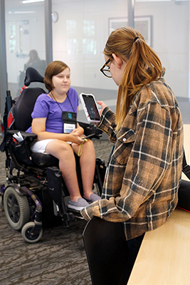 A student looks at her mobile phone.