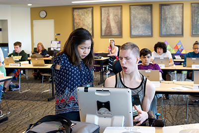 -	Jon Shows fellow Phase I Scholar Teresa how he operates his computer with his eyes.