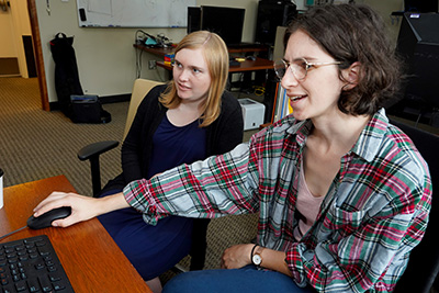 Student with mentor working on computer. Student with mentor working on computer.