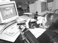 Photo of a student in a wheel chair using a computer