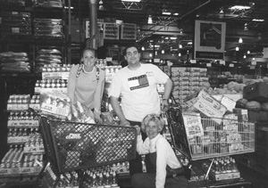 Photo of volunteer Katie, DO-IT Ambassador David, and DO-IT director Sheryl at Costco shopping