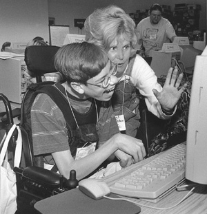 DO-IT director Sheryl and DO-IT Scholar Nick at a computer Photo of DO-IT director Sheryl and DO-IT Scholar Nick at a computer