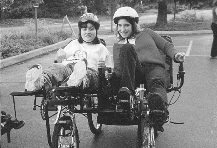 DO-IT Scholars Corina and Crystal on an adapted bike Photo of DO-IT Scholars Corina and Crystal on an adapted bike