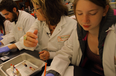 Picture of two students working with an instructor at Seattle BioMed.