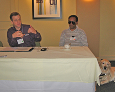 Two presenters share a table.