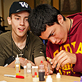 Image of two students conducting a science experiment