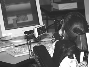 Photo of student in a wheelchair at a computer