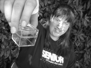 Student holding out a sample box. Photo of student holding out a sample box.
