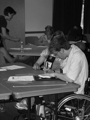 Photo of student in a wheelchair working on an engineering project