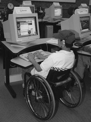 Photo of student in a wheelchair at a computer