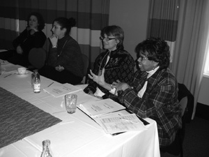 Photo of CBI participants talking while sitting at a large conference table