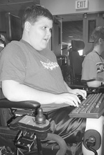 Young man in a wheelchair using a keyboard