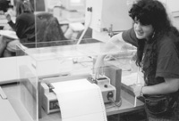 Photo of Anna with a braille printer