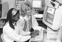 Image of DO-IT Director Sheryl working with a Scholar on a computer.