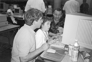 Photo of Bill, Kristin, and interpreter in the computer lab.