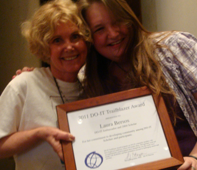 Photo of DO-IT director Sheryl and Laura smiling with the Trailblazer Award plaque.