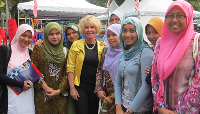 Photo of DO-IT director Sheryl Burgstahler poses for a photo with female students from the University of Malaysia.