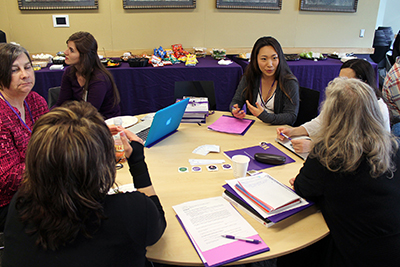 Participants discuss in a group. Participants discuss in a group.