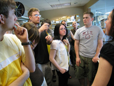 Multiple people in a group listening to an instructor.