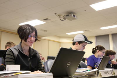 Photo of DO-IT Scholar using her laptop during a Summer Study lab session.