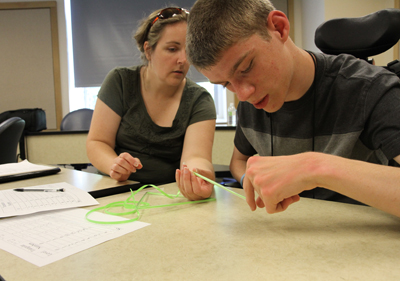 Photo of DO-IT Scholar Cody working on a class project on the UW campus.