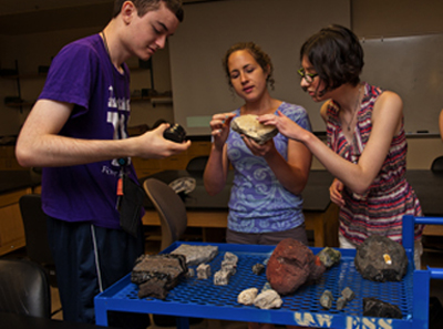 Phase II DO-IT Scholars Peter and Lindsay look at geological rocks with an instructor Photo of Phase II DO-IT Scholars Peter and Lindsay look at geological rocks with an instructor