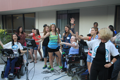 Photo of DO-IT Scholars, Ambassadors, and staff all sing Sheryl Burgstahler's favorite karaoke song, 'Stop! In the Name of Love' during ice cream and karaoke night