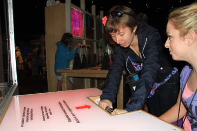 Photo of Phase I DO-IT Scholars Ellen and Olivia using some of the science equipment at the Pacific Science Center