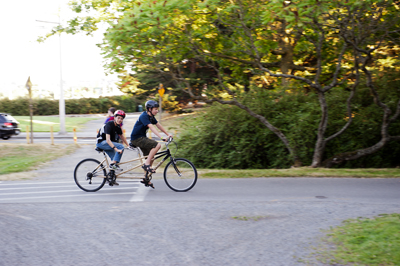 Photo of Phase I DO-IT Scholars Michael and Ryan ride a tandem bicycle on the Burke Gilman trail during Summer Study 2013