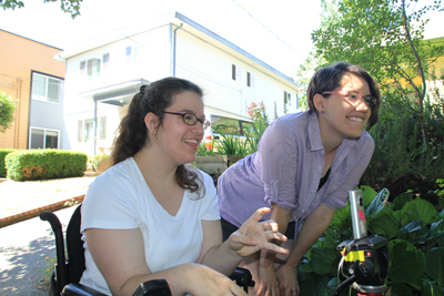 Photo of Phase II DO-IT Scholar Jennifer uses a tripod and camera while Reel Grrls mentor Elise looks on