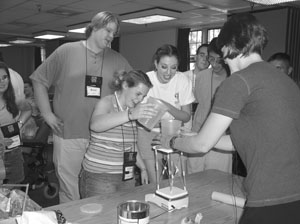 A group of students conducting a science experiment. Image of a group of students conducting a science experiement