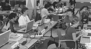 Students using laptops in a computer lab. Image of students using laptops in a computer lab.