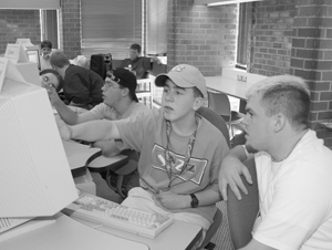 DO-IT Scholars receive computer assistance from DO-IT Ambassadors. Photo of DO-IT Scholars receive computer assistance from DO-IT Ambassadors.