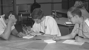 Group of students collecting information during a science experiment Image of a group of students collecting information during a science experiment