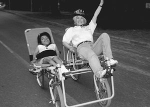 Image of DO-IT Scholar and Sheryl riding an accessible bicycle during Outdoors for All