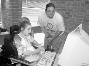 DO-IT staff assists Scholar with a computer problem. Photo of DO-IT staff assisting Scholar with a computer problem.