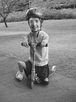 DO-IT Scholar in a helmet that rides a scooter. Image of a DO-IT Scholar in a helmet that rides a scooter.
