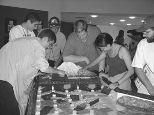 Image of a group of Scholars gathering around for a volcano project