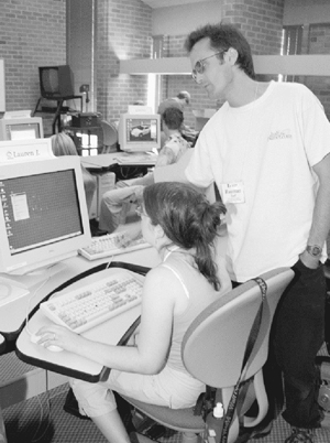 DO-IT staff member works with a Scholar at the computer. Photo of DO-IT staff member working with a Scholar at the computer.